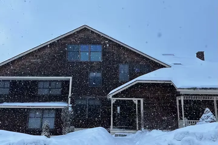 Condo exterior in falling snow